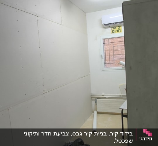 חדר עם קירות גבס, שקי חומרי בניין וכלי עבודה